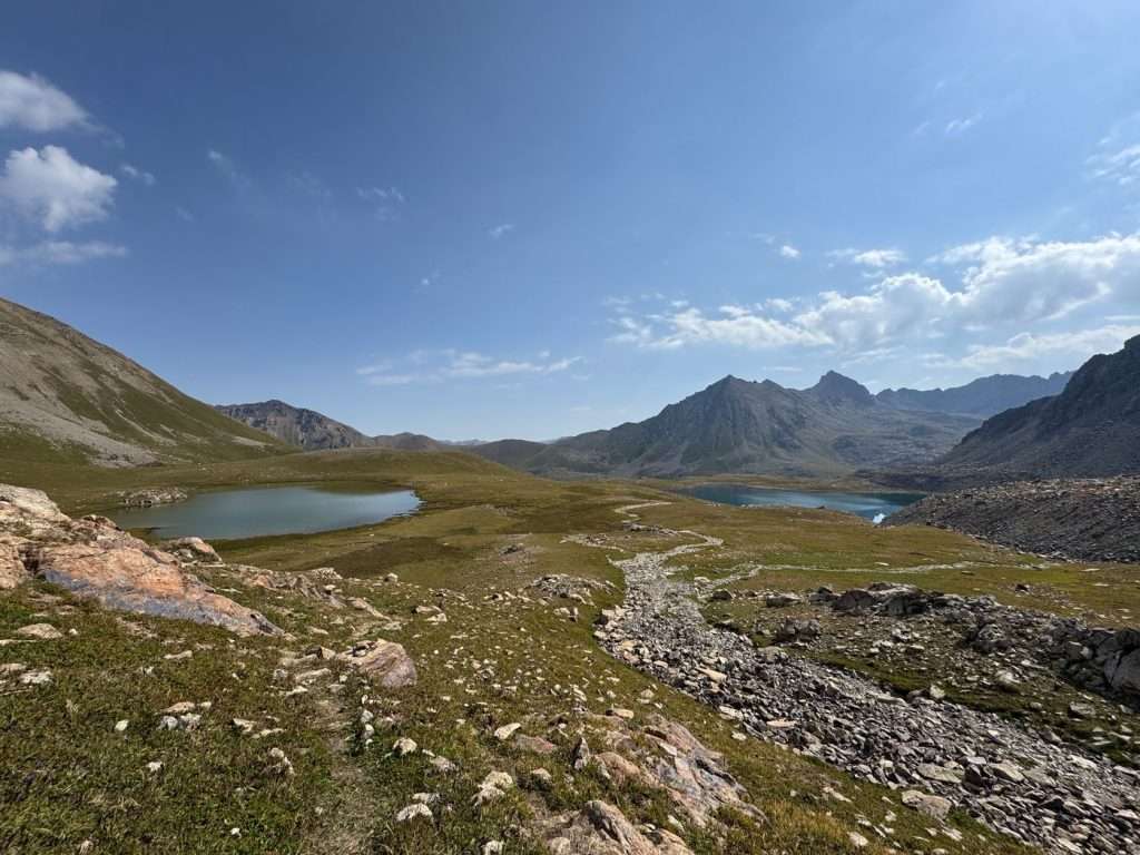 Two of Alianyash lakes on each side, against a blue sky.